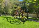 Giant bicycle sculpture in the Emilio Murcia park in Returbiu, under the shade of the trees.
