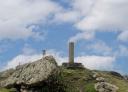 Top of the Llosorio peak with geodetic vertex and partly cloudy sky.