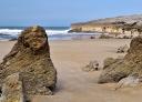 Rock formations on the sand at Toró beach