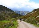 Hiker walking through high mountain pastures in Asturias