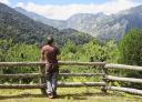 Hiker contemplating the mountains of the Redes Park