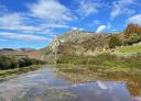 Reflection of the Xamoca in a livestock water pond