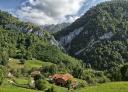 Traditional houses in valley surrounded by steep mountains