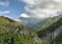 Craggy green peaks under cloudy skies and morning light