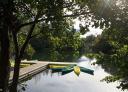 Yellow and green canoes moored at the Valdemurio reservoir jetty.