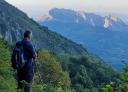 Hiker contemplating the peaks of the Monsacro from the hillside