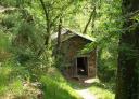 Stone building surrounded by vegetation