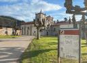 Monastery of San Salvador de Cornellana in the background and informative poster