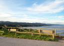 Two wooden benches with sea and cliff views