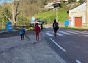 Family of hikers walking along a road