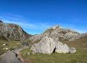Group of hikers walking along a clear path with rock formations all around.