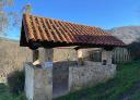 Old traditional washhouse with a reddish tile roof