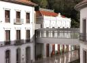White buildings with balconies linked by a footbridge