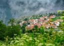 Picturesque mountain village with stone houses amidst greenery