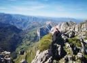 A person at the top of a mountain, enjoying sweeping panoramic views