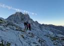 Hikers explore a rocky and steep terrain