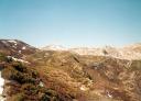 Mountainous landscape with ochre-coloured hillsides and cloudless skies