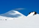 Snow-capped summit of Pico Cornón under clear blue sky
