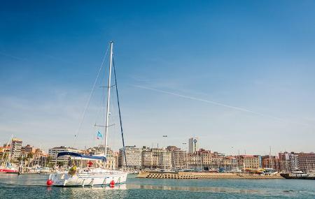 Segelboot beim Einlaufen in den Jachthafen von Gijón/Xixón